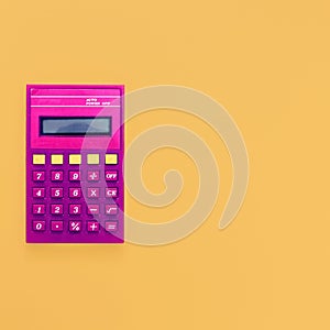 Vintage calculator on bright yellow background