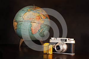 Vintage Camera Film and Globe on Brown with Copy Space