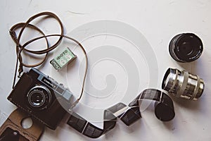 vintage camera, film, retro lenses on white table, copy space