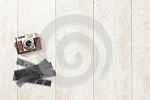 Vintage Camera And Film Strips On Floorboard