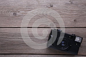 Vintage camera on grey wooden background. Old photo camera on grey background