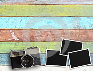 Vintage camera and old blank photo frame on office desk