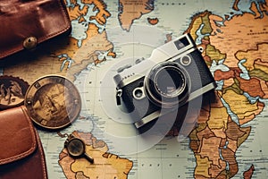Vintage camera on old map background. Travel and adventure concept, Top view travel concept with retro camera films, map and