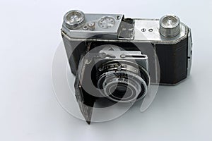 Vintage camera with open lenses on white background