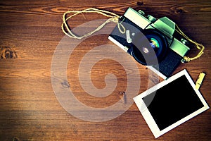 Vintage camera on wooden background.