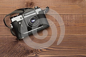 Vintage camera on the wooden background