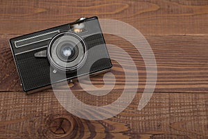 Vintage camera on the wooden background