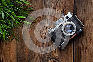 Vintage camera on wooden background.