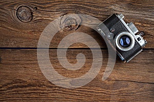 Vintage camera on wooden background.