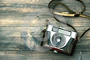 Vintage camera on wooden background. Retro style toned picture