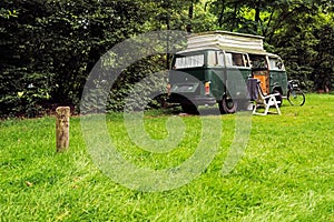 Vintage Camping Van on Meadow in Forest.