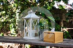 Vintage candle lanterns, tissue boxes and ornamental plants