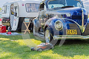 Vintage car and camper trailer on display at car show