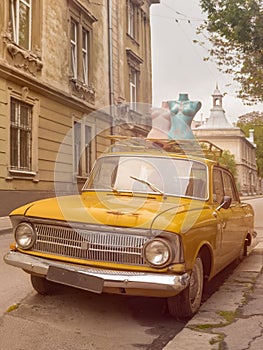 Vintage car. Classical retro car. Old style car. Vechicle concept. Mannequins on the street. photo