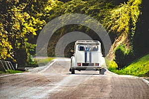 Vintage car country winding road back view friends road trip