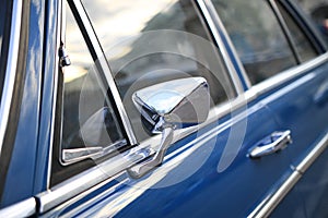 Vintage car detaill. Window and rear mirror.