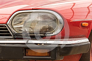 Vintage car headlight. Retro headlamp with wiper on classic vehicle.