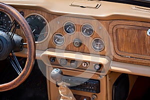 Vintage car interior - Wooden steering wheel and dashboard