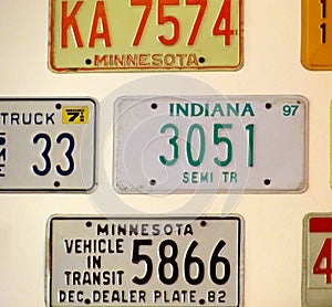 Vintage car license plates from different USA states hanging on the wall