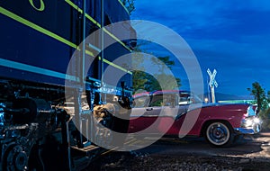 Vintage car racing across railroad crossing