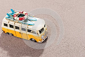 Vintage car with surfboards and rescue ring on the beach