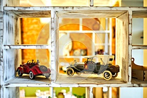 Vintage car toy standing on the shelf jpg photo