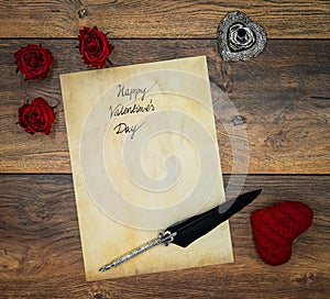 Vintage card with red cuddle hart, red roses, ink and quill on vintage oak, love letter on antique oak - top view