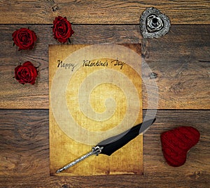 Vintage card with red cuddle hart, red roses, ink and quill on vintage oak, love letter on antique oak - top view