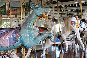 A vintage carousel with white horses