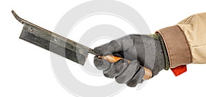 Vintage carpenter hacksaw in worker hand in black protective glove and brown uniform isolated on white background