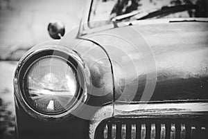 Vintage cars abandoned and rusting away black and white photo