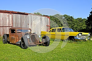 Vintage cars alongside a railroad box car