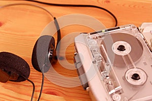 Vintage cassette tape audio player and Retro headphone on wooden background, gadgets for The 70-80-90`s