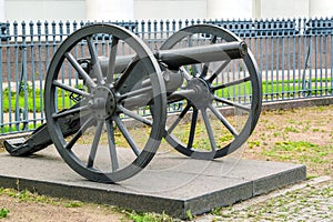 Vintage cast iron cannon on a carriage with large wheels