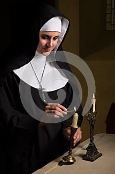 Vintage catholic nun burning candles