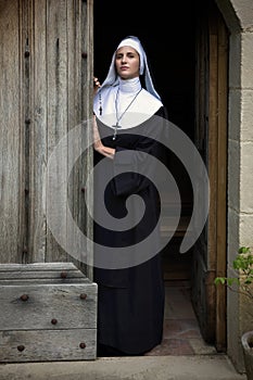 Vintage catholic nun welcoming in chapel photo