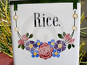 Vintage Ceramic Container with Rice written in Art Deco Style stencil font and a wreath of cornflowers and roses