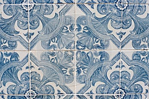 Vintage ceramic tiles of faded blue colour on the streets of Lagos, Algarve coast, Portugal. Traditional portugese floral ornate