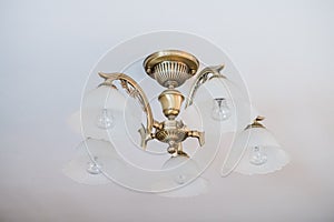 Vintage chandelier. An antique lamp in the interior, old sconce