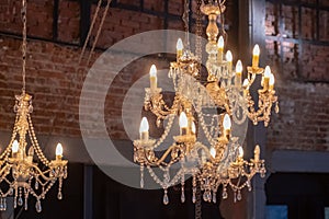Vintage chandeliers on the background of old walls and Windows. The old interior of the room.