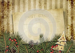 Vintage Christmas background with old postcard and firtree