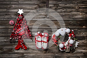 Vintage christmas decoration: red, white things on wooden background.