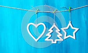 Vintage Christmas decorations hanging on string on blue background