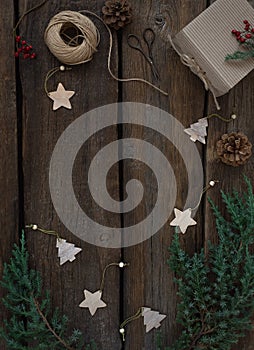 Vintage Christmas frame a board of fresh tree branches, cones, wooden christmas toys.