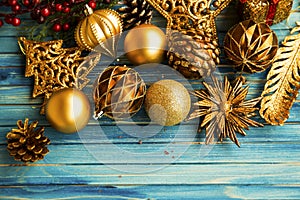 Vintage Christmas golden balls and decorations on painted old wooden board, festive decorations greeting, winter holidays season