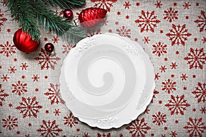 Vintage Christmas plate on holiday background with Red Christmas ornaments. Xmas card. Happy New Year