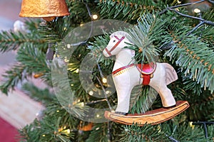 Vintage Christmas tree toy rocking horse made of papier-mache on Christmas tree with a garland