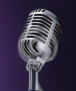 Vintage chrome microphone on purple