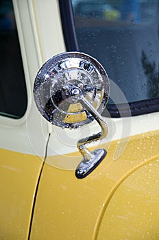 Vintage Chrome Mirror on Antique Yellow and White Car