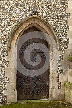 Vintage church wooden door in stone archway